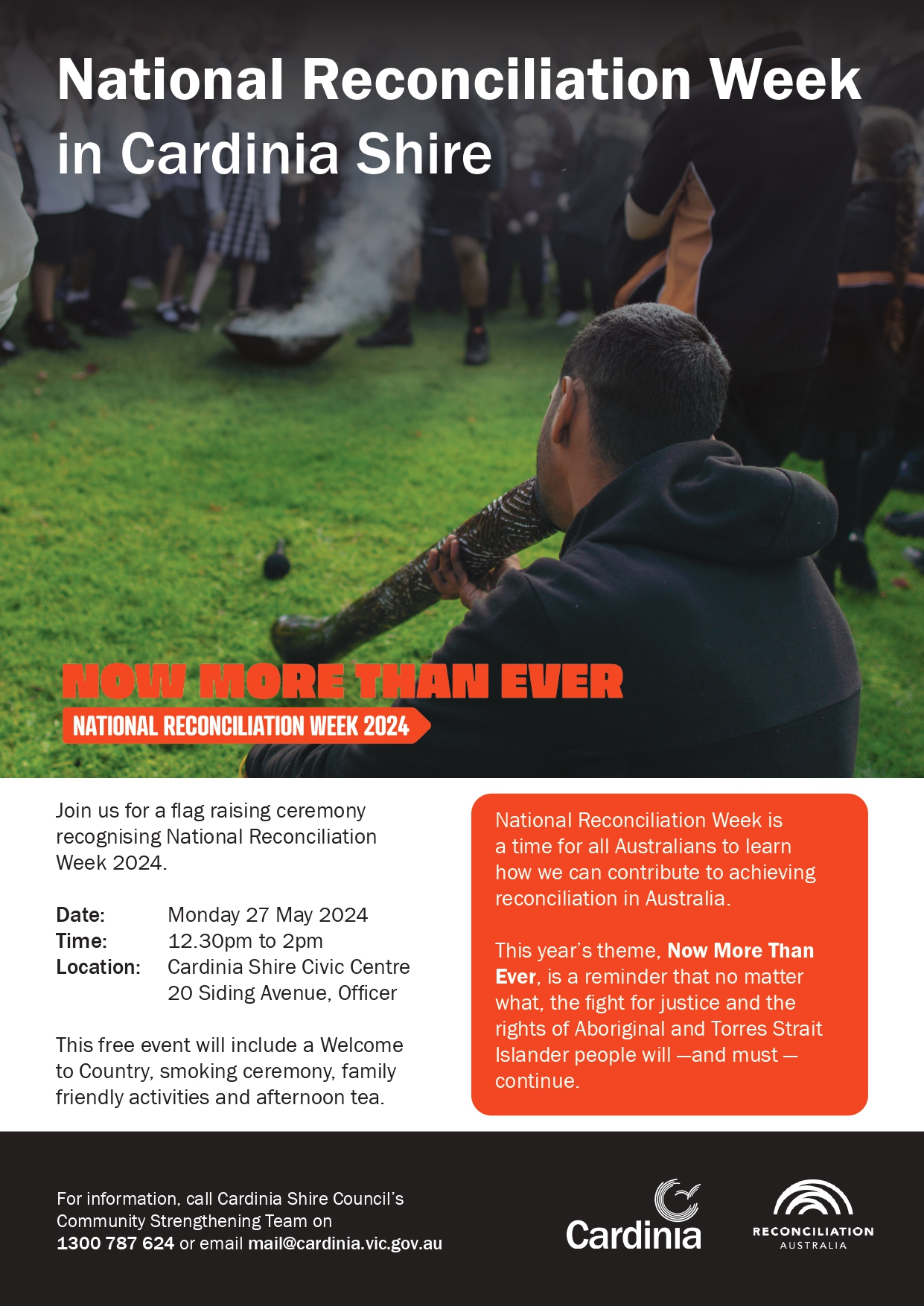Aboriginal male sitting on grass playing the Didgeridoo for school students